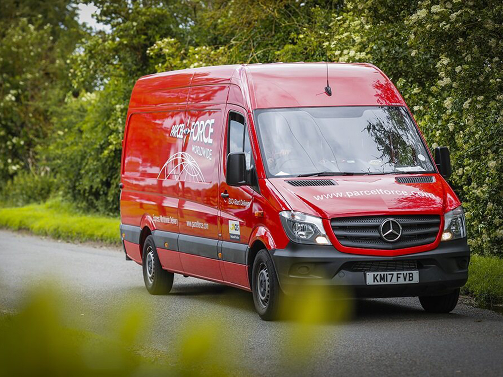Van close up driving down a country road