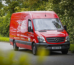 Parcelforce red van driving down the street