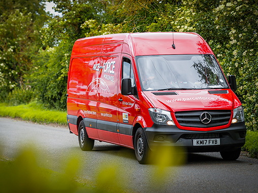 Van close up driving down a country road