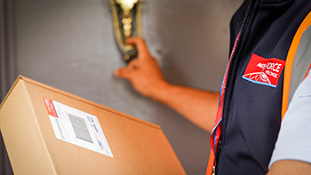 driver with parcel at door