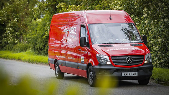 Van close up driving down a country road